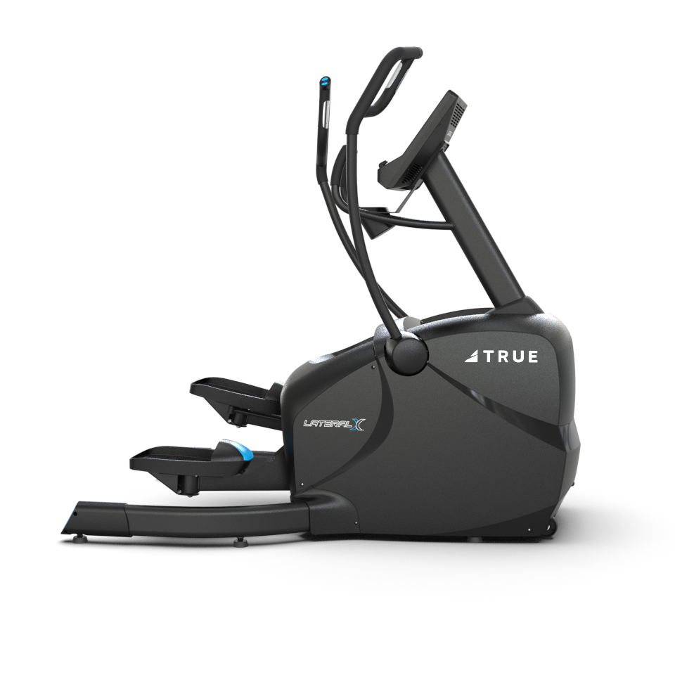 A black elliptical exercise machine with a digital display, handles, and foot pedals, branded TRUE and labeled LateralX. The machine is shown from a side view on a white background.