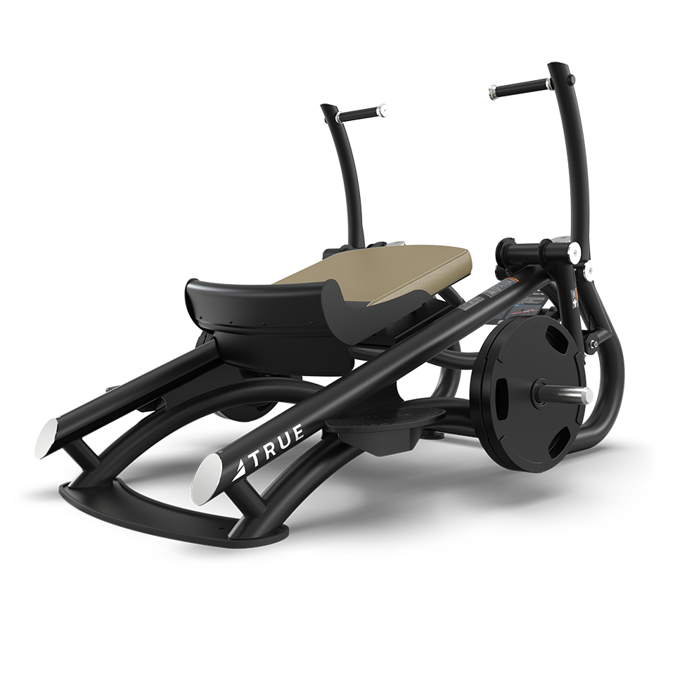 A black and tan fitness machine with a curved frame, padded seat, and handles, designed for leg or rowing exercises; the brand name TRUE appears on the side.