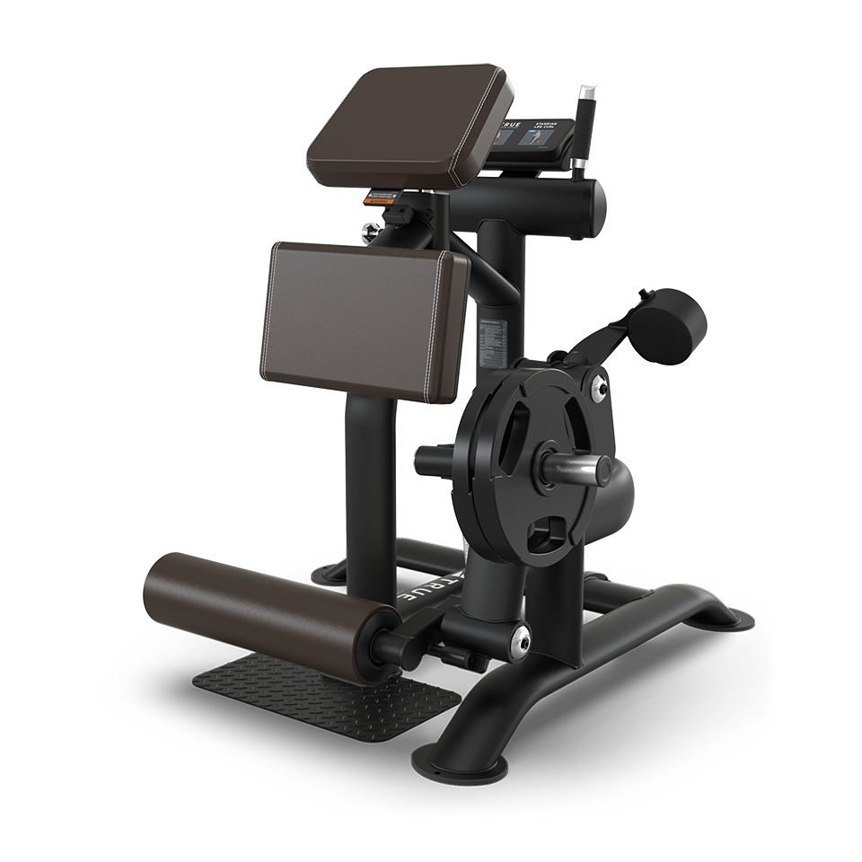 A black and brown gym machine with padded supports and rollers, designed for seated leg curls or extensions, with a plate-loaded resistance mechanism and a sturdy metal frame.