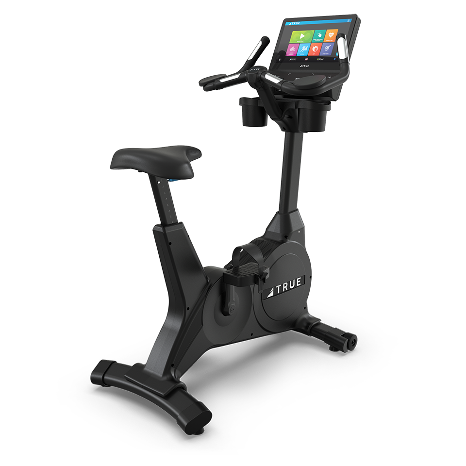 A stationary exercise bike with a touchscreen display, black frame, adjustable seat, pedals, and handlebars, set against a plain white background.