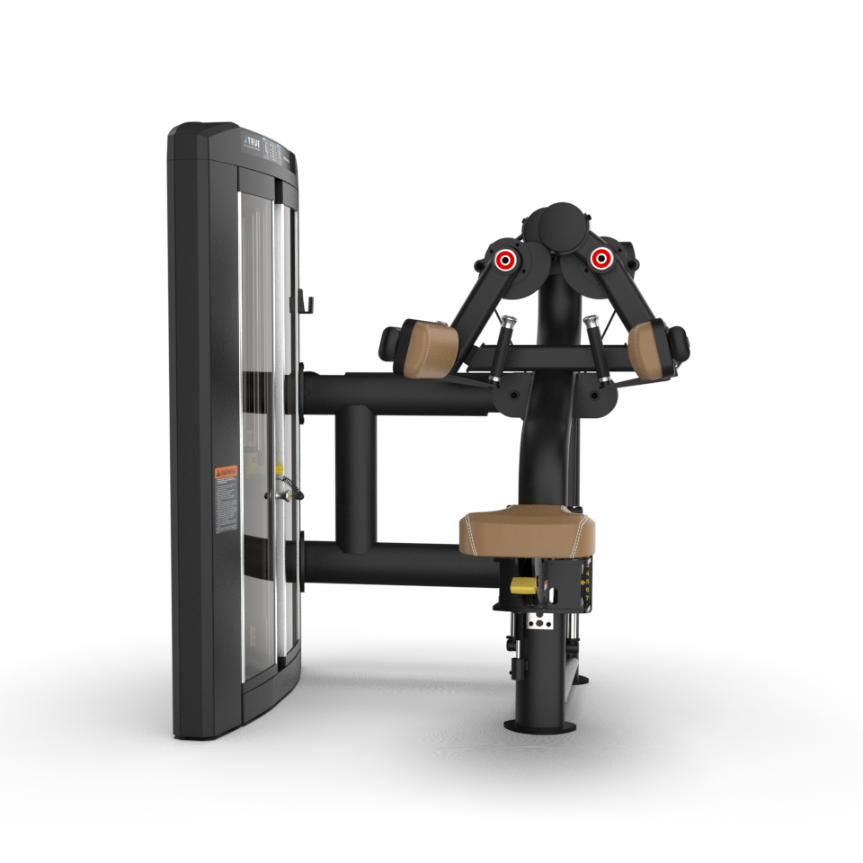 A black and tan seated shoulder press machine with padded armrests and backrest, adjustable seat, and weight stack on the left, designed for strength training in a gym setting.