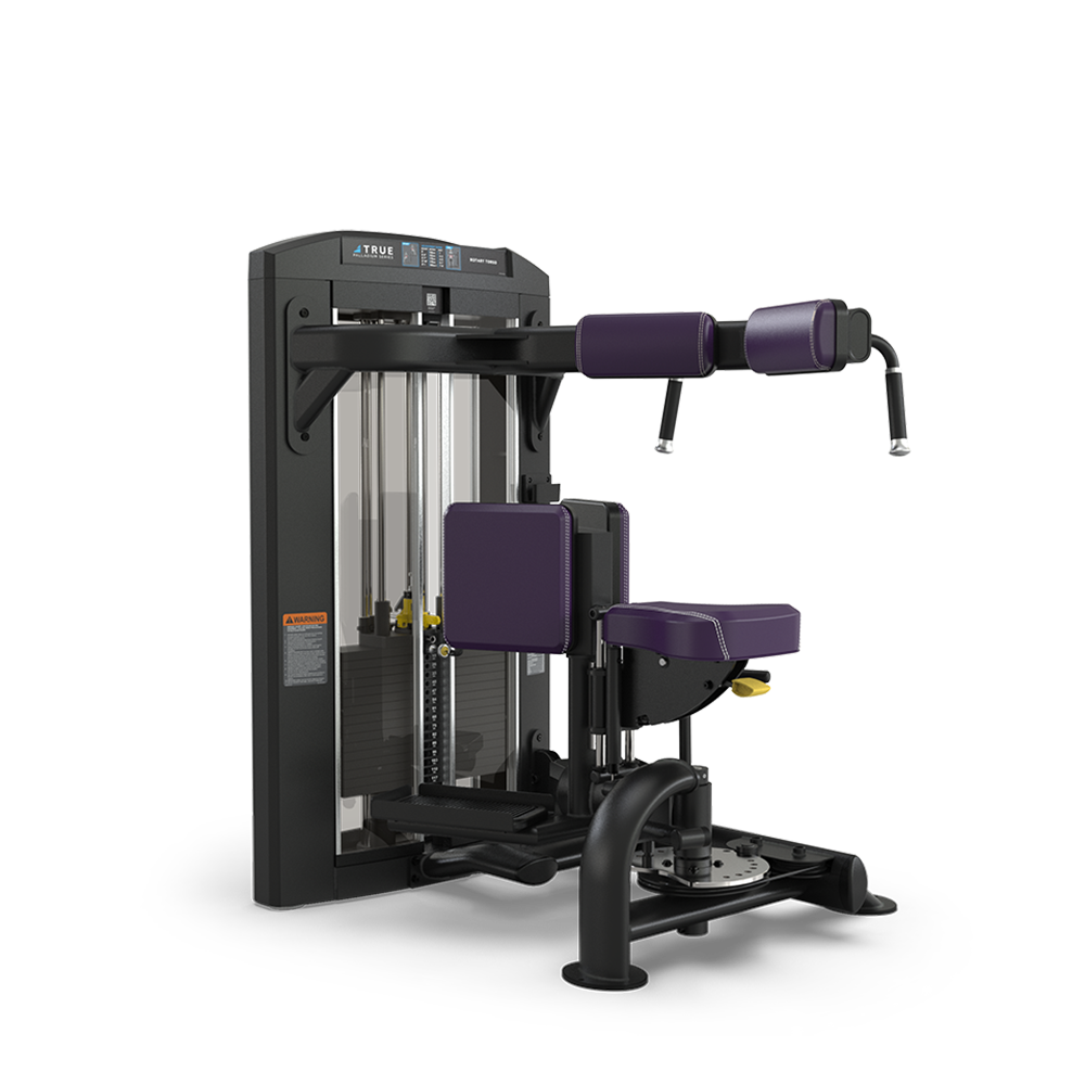 A black and purple gym machine with padded seats and armrests, designed for exercising the torso, especially for performing ab crunch and back extension workouts. The machine has adjustable settings and a weight stack.